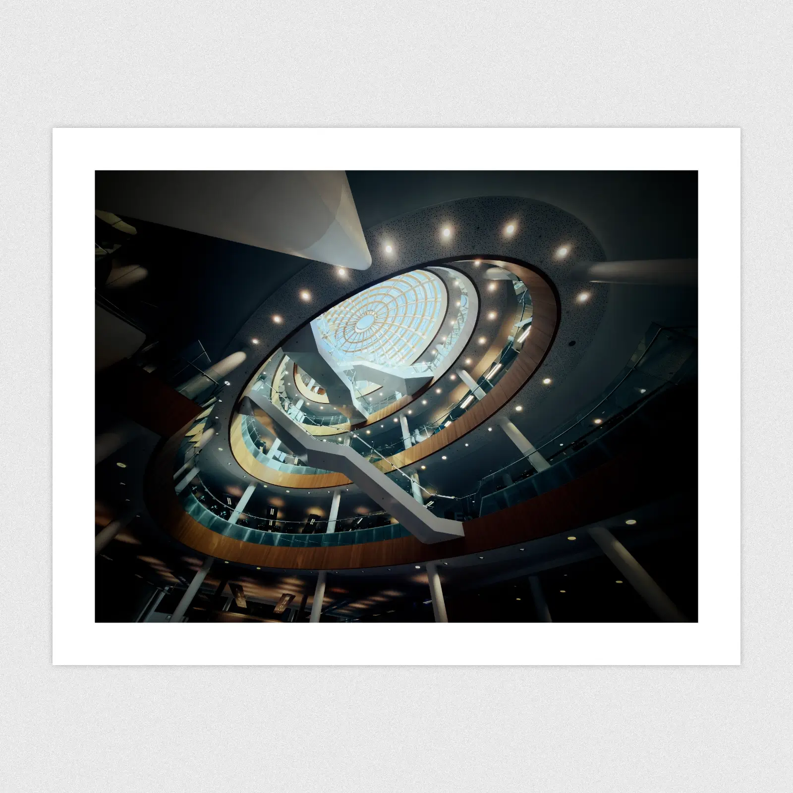 Portfolio A futuristic library interiour with stairs leading up towards a glass dome.