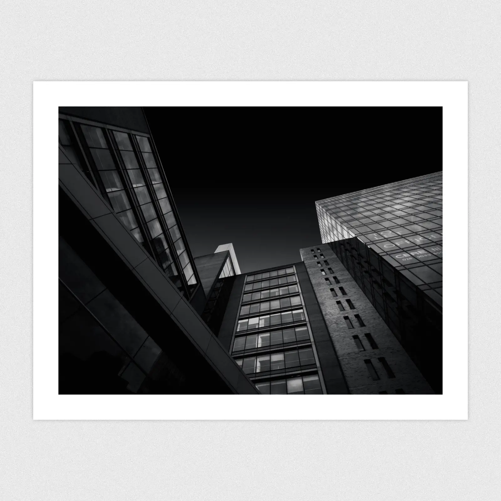 Portfolio A dark mode edit looking up at a building that forms lots of geometric shapes.