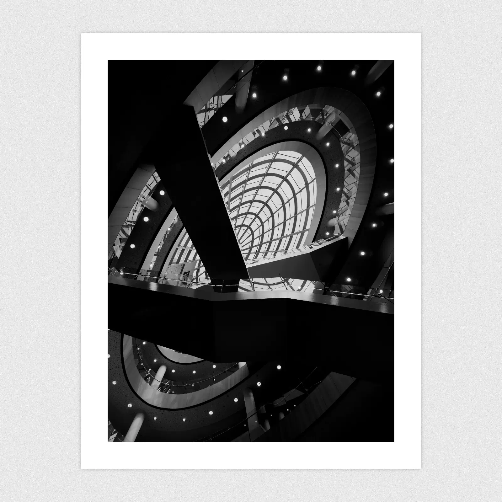 A black and white edit of the inside of Liverpool Central Library looking up towards a glass dome.