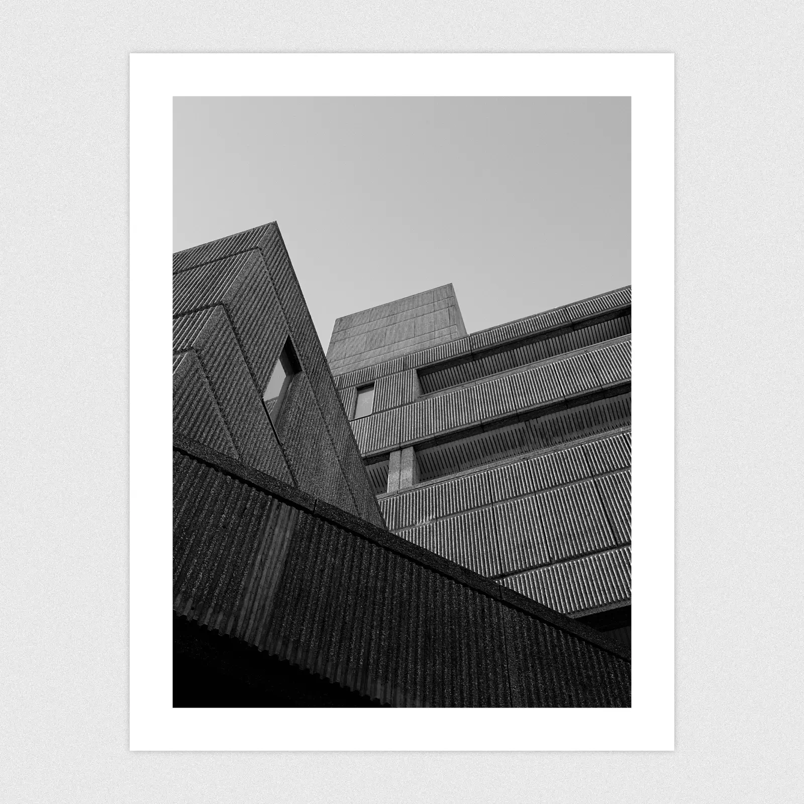 Black and white photo of geometric shapes created by a Brutalist architecture building.