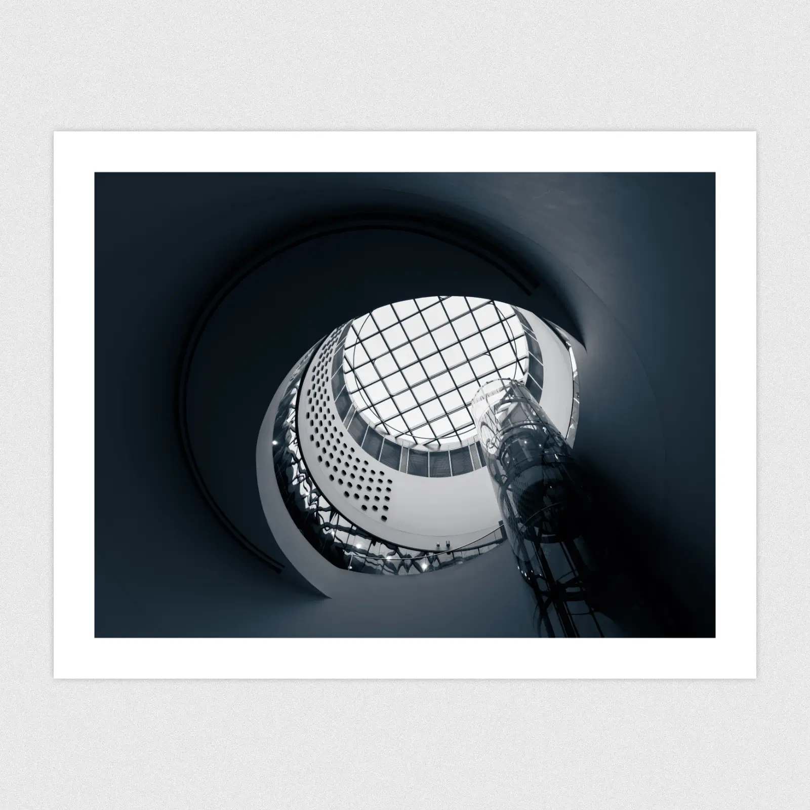 Portfolio A blue monochrome edit of a glass dome in the ceiling with a lift going up to it.