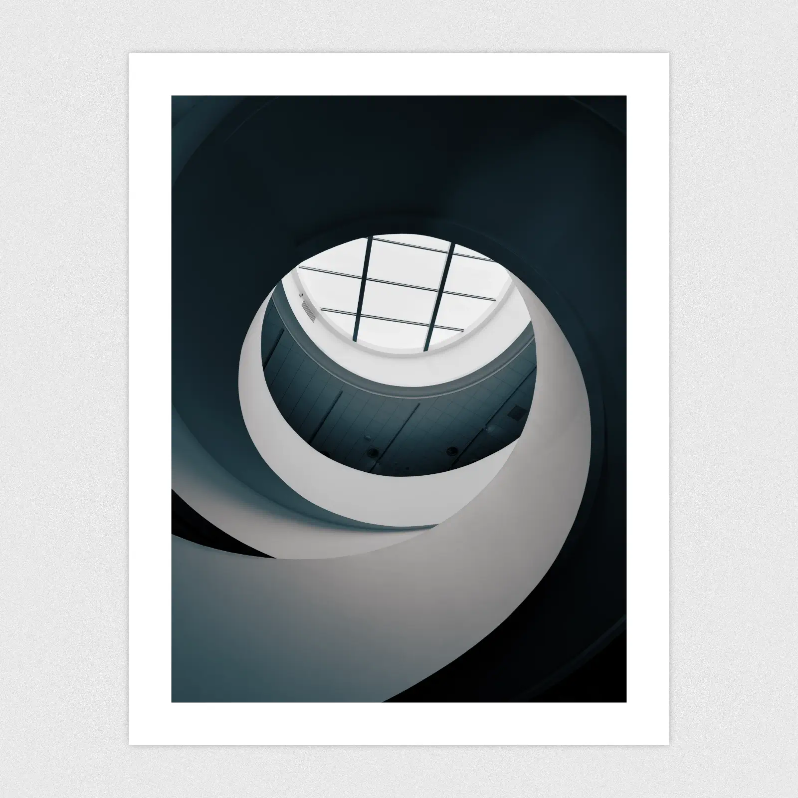 Portfolio A spiral staircase leading up towards a ceiling window.