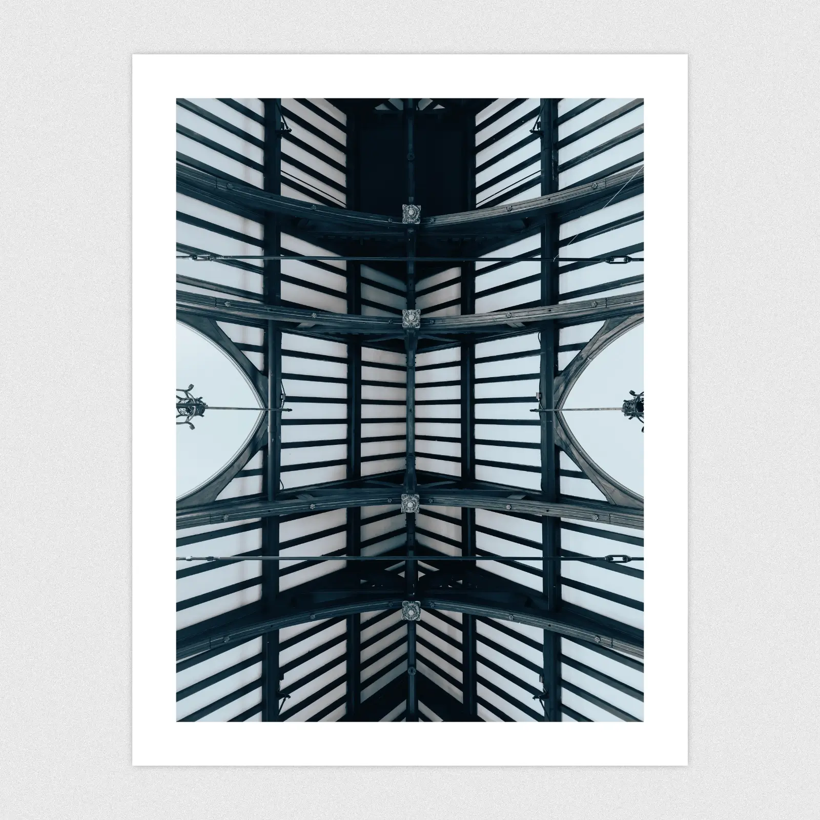 Portfolio A symmetrical ceiling with wooden beams.