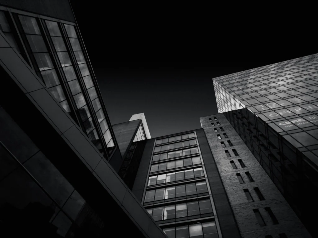 Black and white modern architecture building with dark sky background.