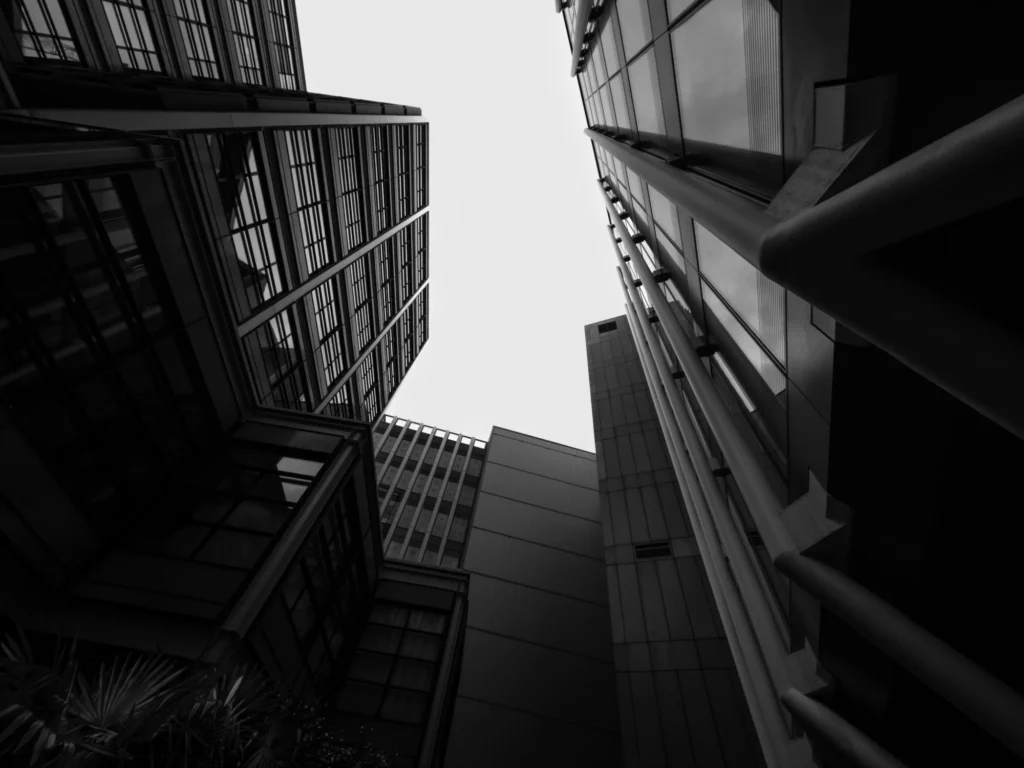 Looking up at a collection of buildings forming many geometric shapes.